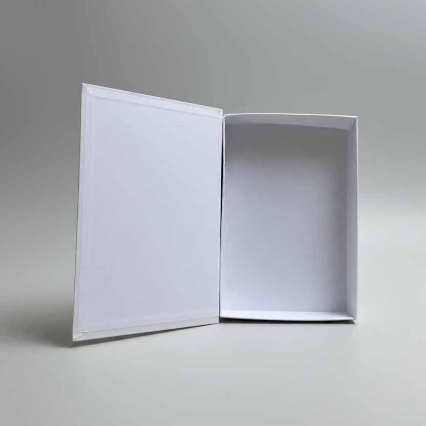 Open white cardboard box on a light gray floor