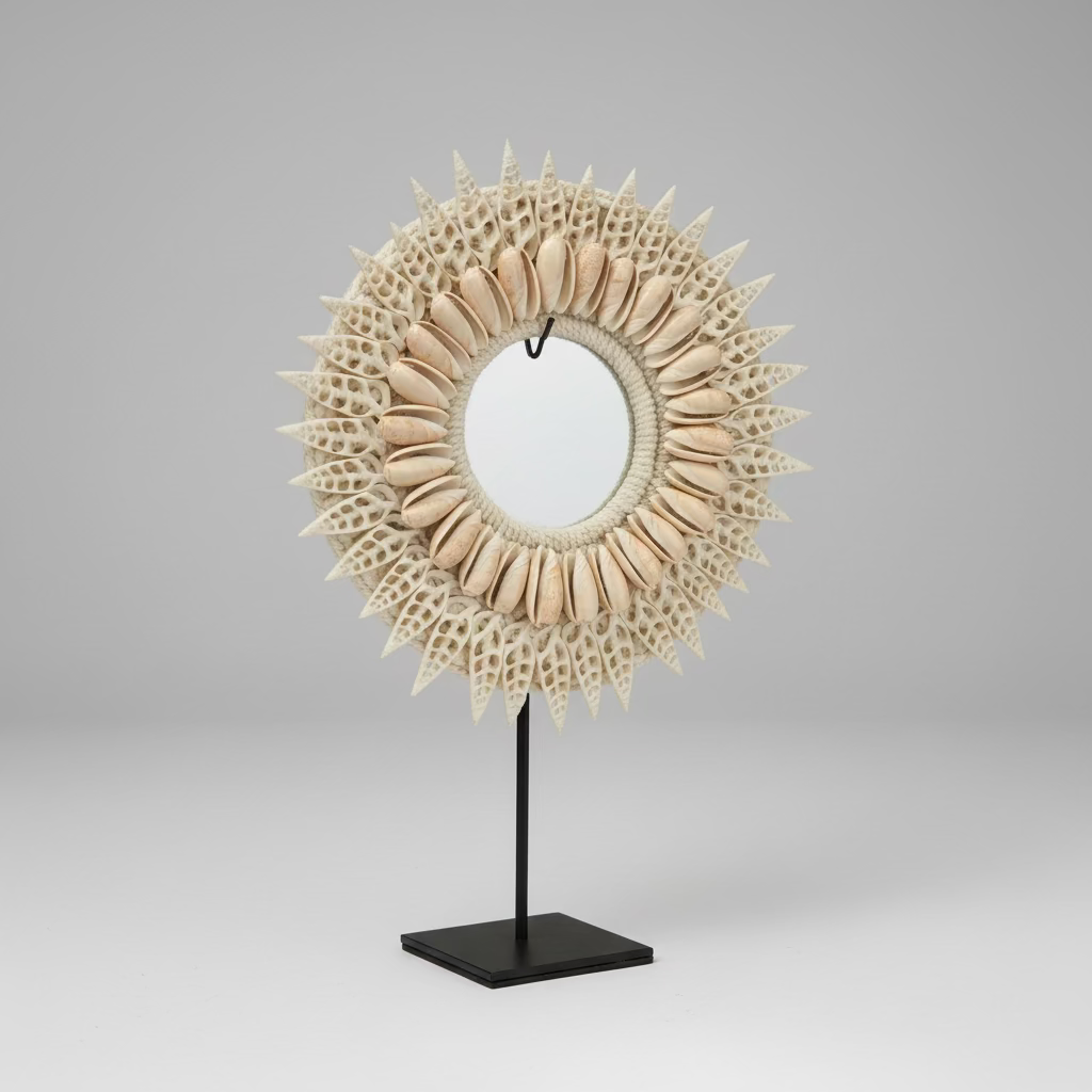 Decorative sunflower-shaped mirror on a stand in front of a computer screen.