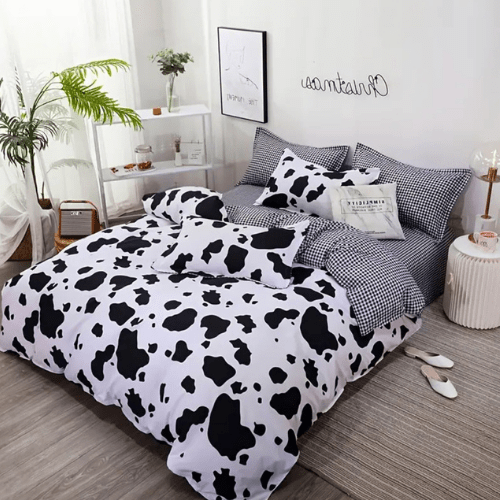 Single 4 - piece reversible duvet cover set showcasing a charming black and white cow pattern. - BusDeals