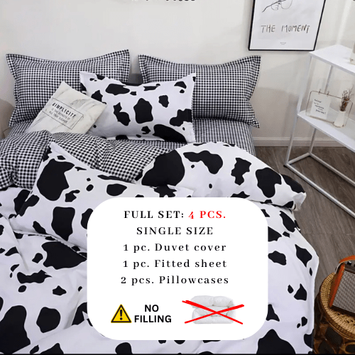 Single 4 - piece reversible duvet cover set showcasing a charming black and white cow pattern. - BusDeals