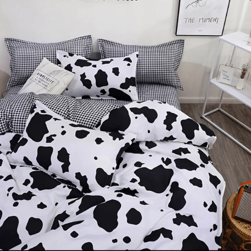 Single 4 - piece reversible duvet cover set showcasing a charming black and white cow pattern. - BusDeals