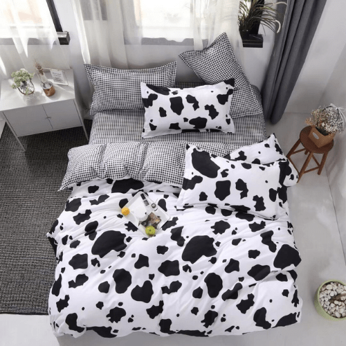Single 4 - piece reversible duvet cover set showcasing a charming black and white cow pattern. - BusDeals
