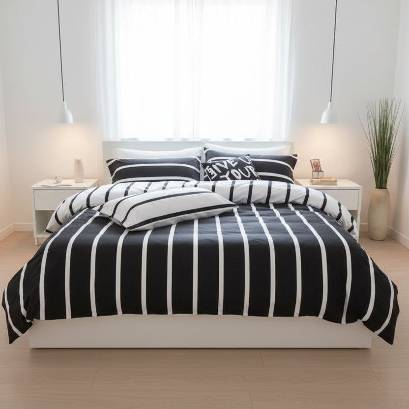 Black and white striped bedding set on a bed in a child's room with toys and books around.