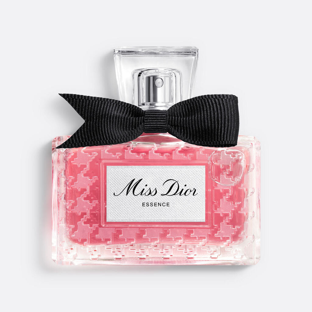 Miss Dior perfume bottle with pink packaging and black bow on a white background