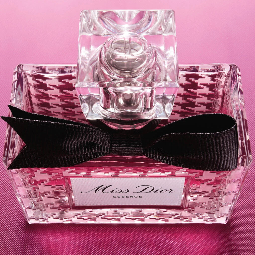 Miss Dior perfume bottle with pink floral design on a pink background