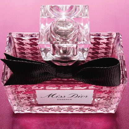 Miss Dior perfume bottle with pink floral design on a pink background