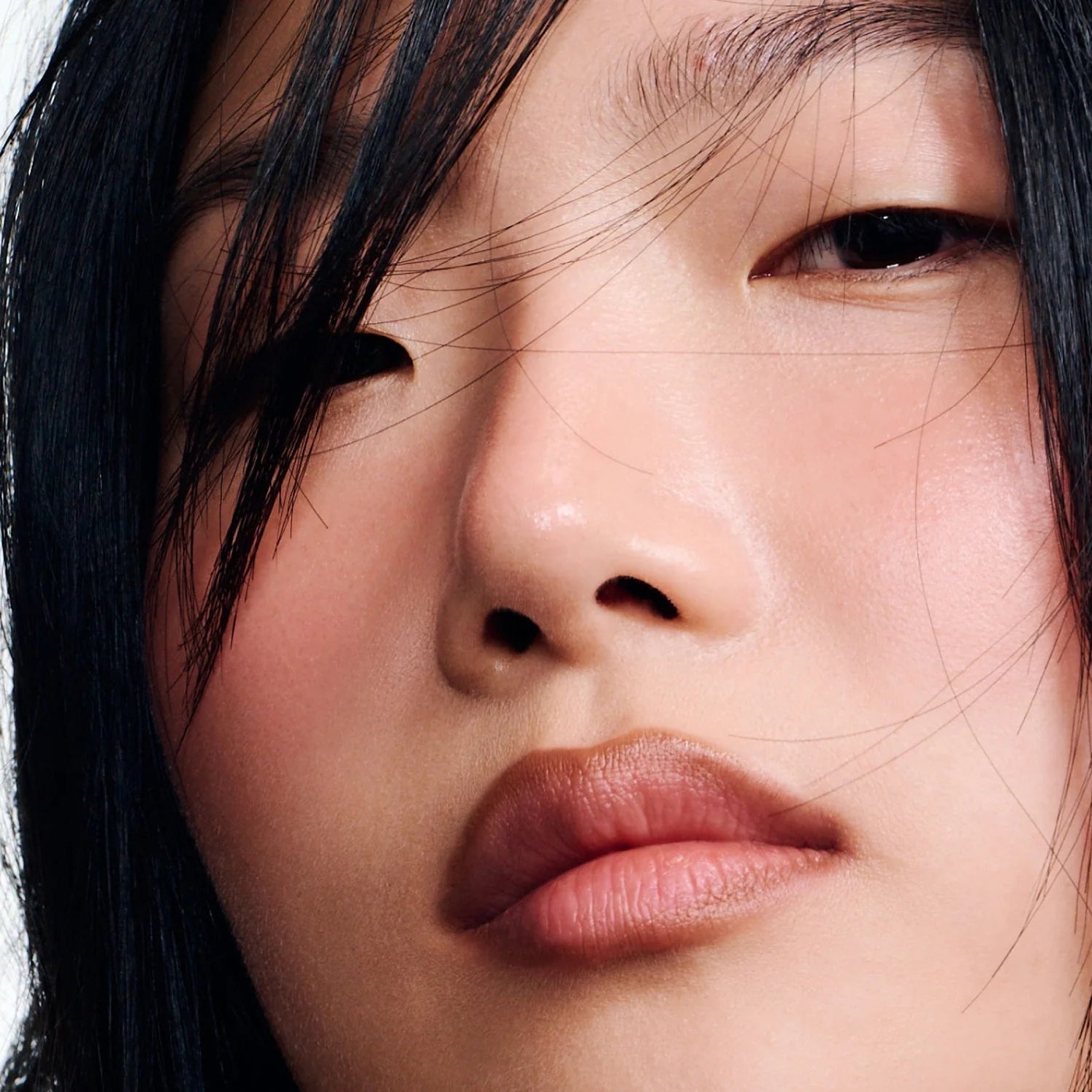 Close-up of a person with dark hair and light skin.
