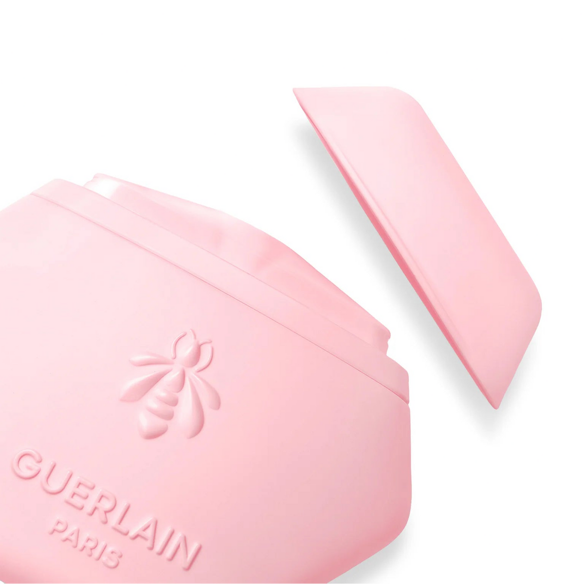 Guerlain Paris pink jar with its matching lid resting beside it on a clean white background.