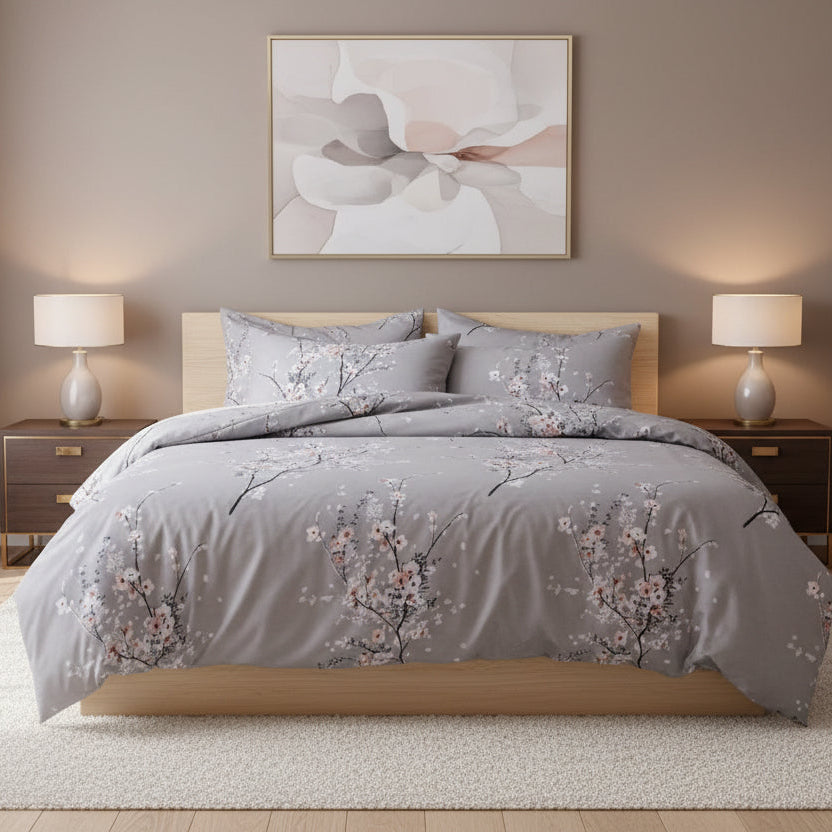 Gray floral comforter cover set on a bed in a bedroom with abstract art and lamps. Unite Arab Emirates