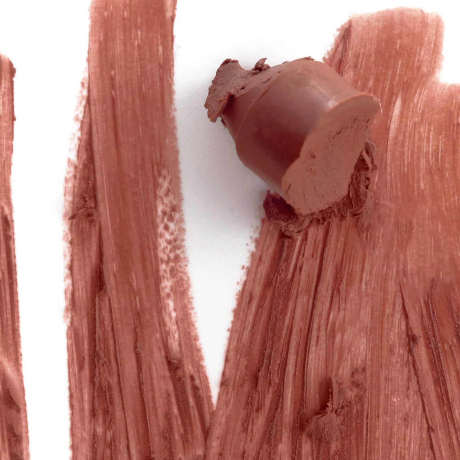 Close-up of a chocolate bar with a piece broken off, surrounded by chocolate swatches on a white background.