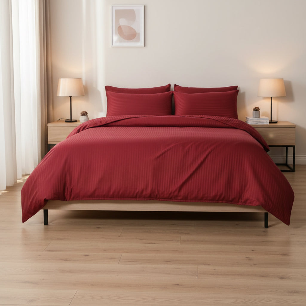 Red bedding set on a bed in a bedroom with two nightstands and lamps. Unite Arab Emirates hotel bedding Luxury bedsheet 