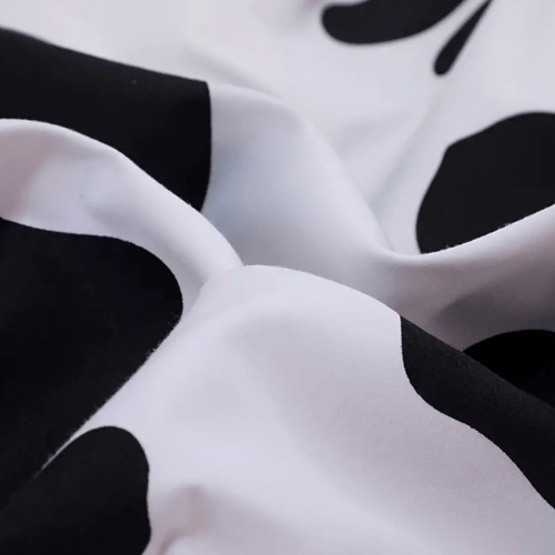 Single 4 - piece reversible duvet cover set showcasing a charming black and white cow pattern. - BusDeals