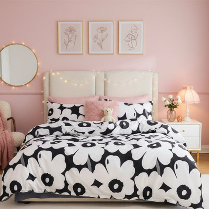 Bedroom with a bed featuring a black and white floral patterned comforter.